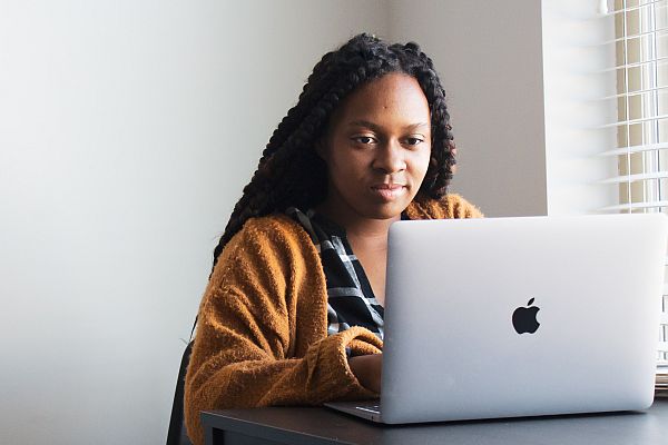Black woman sitting at laptop